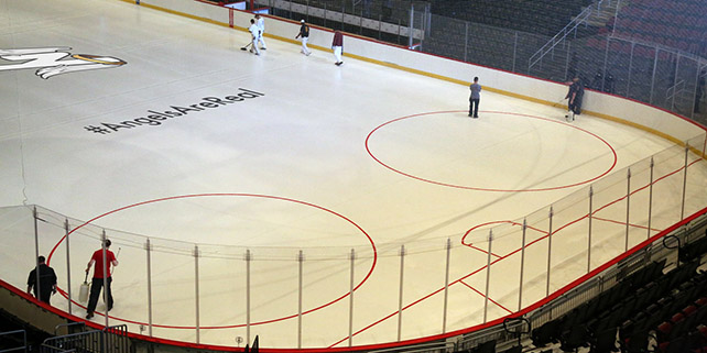 Learn Photoshop and create pictures with realistic overlays like this picture of a team logo on ice.