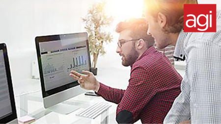 Design courses, video editing classes, UX classes & digital marketing training AGI student pointing to screen in Google Analytics class.